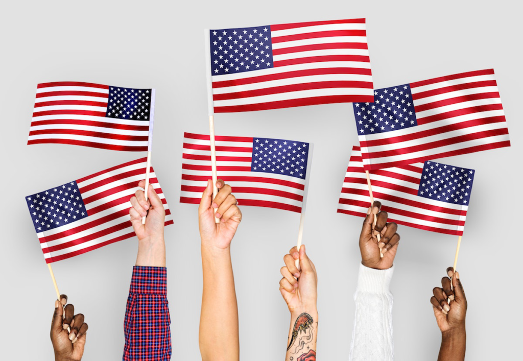 a group of hands holding flags