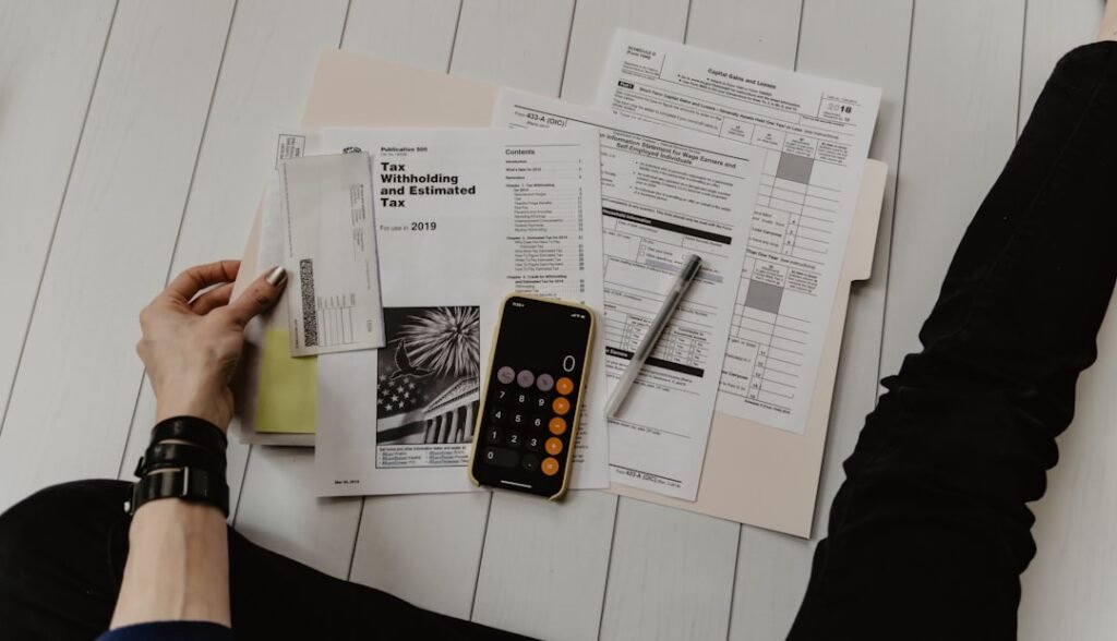 a person holding a paper and a pen